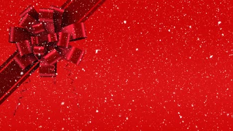 Digital-animation-of-red-ribbon-with-gift-bow-against-red-background-4k