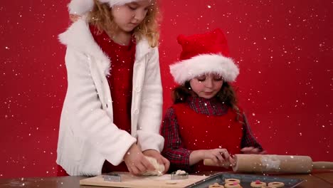Videokomposition-Mit-Fallendem-Schnee-über-Dem-Schreibtisch-Und-Kindern,-Die-Kekse-Zubereiten