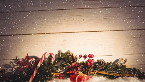 Falling-snow-with-Christmas-decoration-on-wood