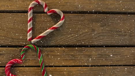Falling-snow-with-Christmas-hearts-decoration-on-wood