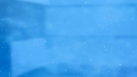 Falling-snow-with-blue-background