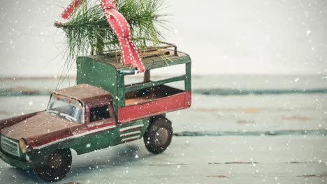 Model-car-with-a-christmas-tree-on-its-roof-combined-with-falling-snow