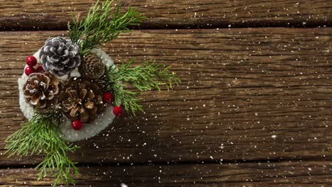 Falling-snow-with-Christmas-decoration-on-wood