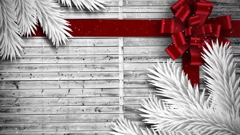 Video-composition-with-snow-over-Christmas-gift--ribbon-on-wood