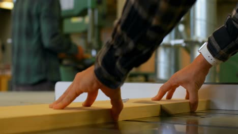 Carpenter-using-table-saw-in-workshop-4k