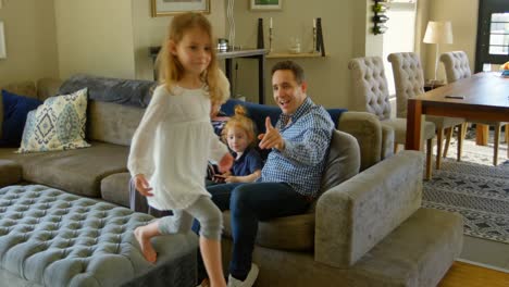 Family-having-fun-in-living-room-at-home-4k