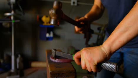 Female-metalsmith-molding-horseshoe-in-factory-4k