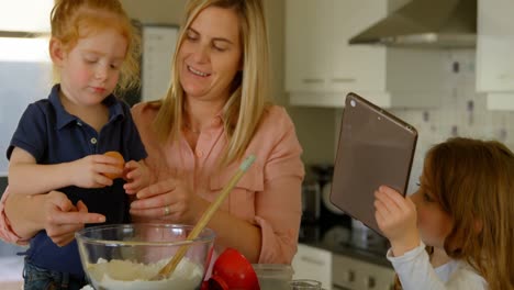 Mother-and-children-preparing-food-in-kitchen-4k