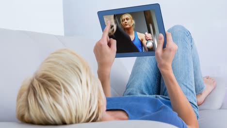 Digital-animation-of-woman-watching-a-video-of-herself-exercising-in-the-digital-tablet-4K