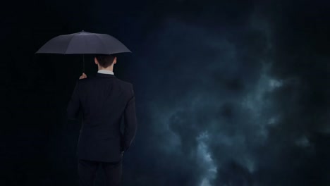 Businessman-looking-at-storm-with-umbrella-