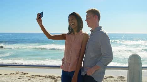 Happy-couple-taking-selfie-on-mobile-near-railings-4k