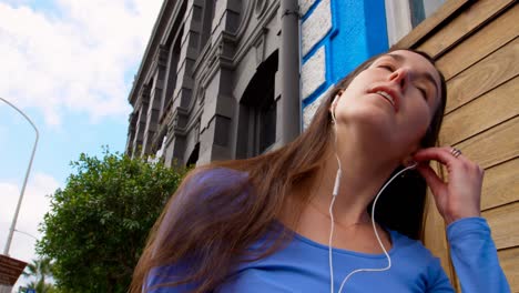 Happy-beautiful-young-woman-listening-music-on-mobile-phone-4k