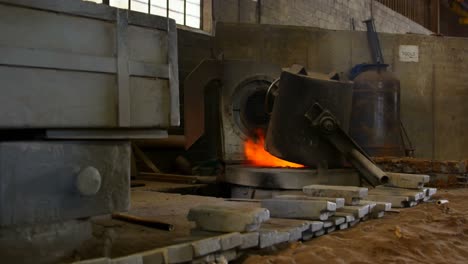 Melting-metal-being-heated-in-workshop-4k