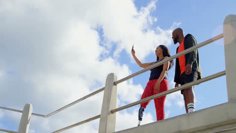 Couple-taking-selfie-with-mobile-phone-near-railing-4k