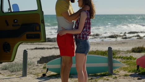 Young-couple-embracing-at-beach-on-a-sunny-day-4k-