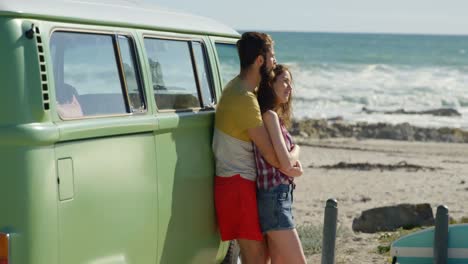 Young-couple-embracing-near-van-on-a-sunny-day-4k
