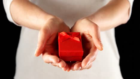 Close-up-of-hand-holding-small-red-gift-box-4k