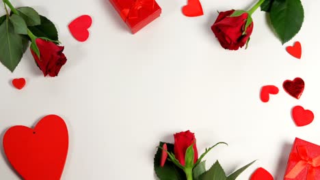 Rosas-Rojas,-Cajas-De-Regalo-Y-Confeti-En-Forma-De-Corazón-Sobre-Una-Superficie-Blanca-En-Formación-De-Círculo-4k