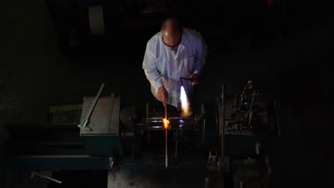 High-angle-view-of-male-worker-making-glass-in-glass-factory-4k