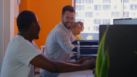 Side-view-of-mixed-race-male-executives-interacting-with-each-other-in-modern-office-4k
