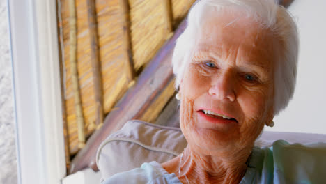 Front-view-of-old-Caucasian-senior-woman-looking-at-camera-in-a-comfortable-home-4k