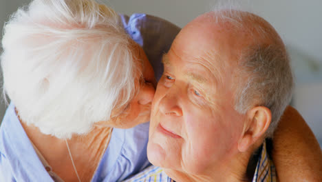 Close-up-of-Caucasian-senior-woman-kissing-senior-man-at-comfortable-home-4k