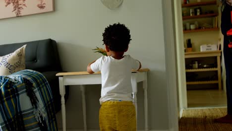 Rear-view-of-little-black-boy-playing-in-a-comfortable-home-4k