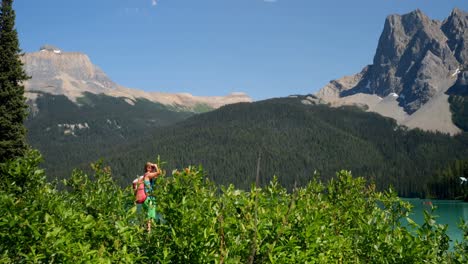 Side-view-of-young-caucasian-female-hiker-clicking-selfie-with-smartphone-near-riverside-4k