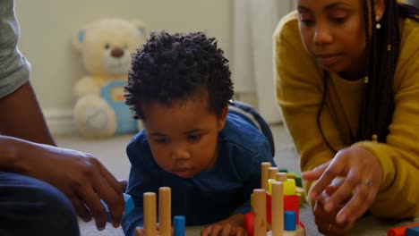 Close-up-of-young-black-parents-and-son-playing-with-toys-in-a-comfortable-home-4k