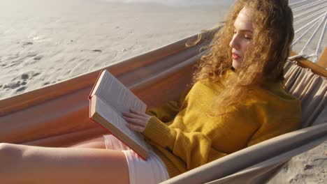 Woman-reading-a-book-in-hammock-at-beach-4k