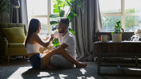 Side-view-of-young-asian-couple-having-fun-together-in-living-room-at-home-4k