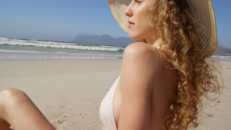 Woman-relaxing-at-beach-on-a-sunny-day-4k
