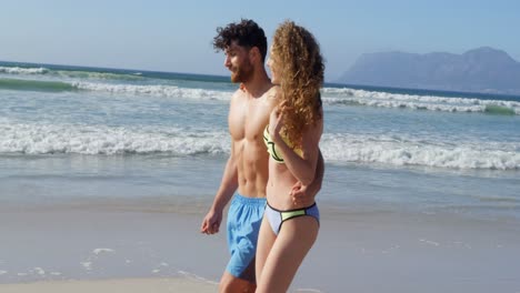 Romantic-couple-walking-together-at-beach-4k