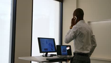 Businessman-talking-on-mobile-phone-in-office-4k