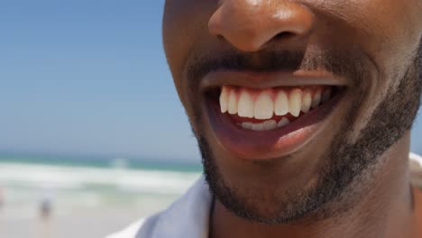 Close-up-of-man-smiling-at-beach-on-a-sunny-day-4k