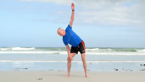 Front-view-of-old-caucasian-man-exercising-at-beach-4k