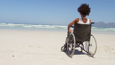 Disabled-woman-sitting-on-wheelchair-at-beach-4k
