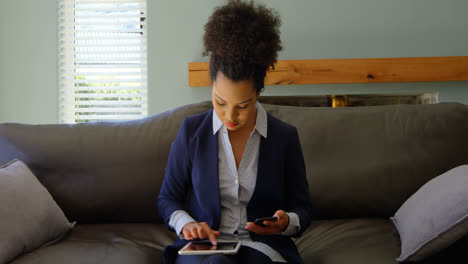Young-Mixed-race-businesswoman-using-mobile-phone-at-home-4k