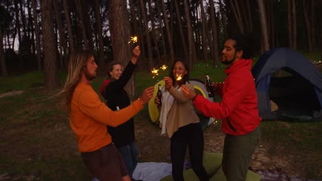Friends-having-fun-with-sparklers-in-the-forest-4k