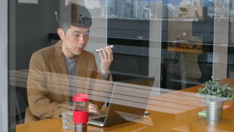 Junge-Asiatische-Geschäftsleute-Diskutieren-über-Ein-Digitales-Tablet-Im-Modernen-Büro-4K