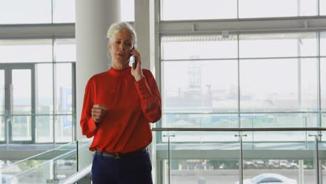 Senior-Caucasian-businesswoman-talking-on-mobile-phone-in-office-4k
