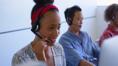 Pretty-mixed-race-customer-sales-executives-talking-on-headset-in-modern-office-4k