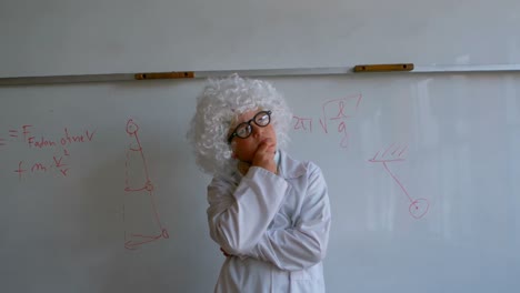 Cute-Caucasian-schoolboy-in-white-wig-with-hand-on-chin-standing-in-school-laboratory-4k
