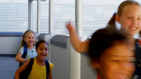 Schoolkids-with-schoolbags-running-in-the-corridor-at-school-4k