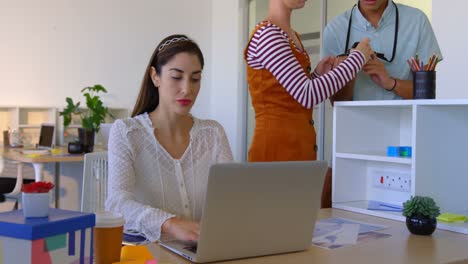 Caucasian-businesswoman-working-on-laptop-at-desk-in-modern-office-4k