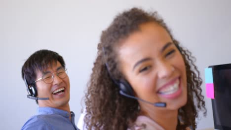Happy-multi-ethnic-customer-sales-executives-talking-on-headset-in-modern-office-4k