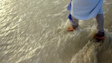 Active-senior-woman-walking-on-the-sea-at-beach-4k