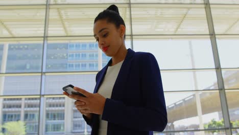 Businesswoman-using-mobile-phone-in-the-office-4k