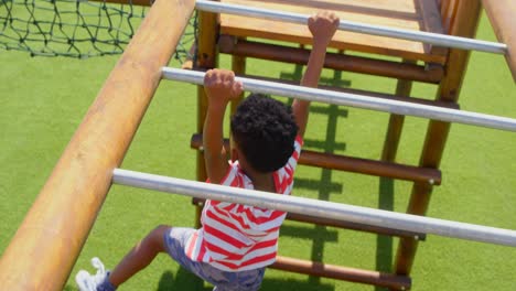 High-angle-view-of-African-American-schoolboy-playing-on-horizontal-ladder-in-school-playground-4k