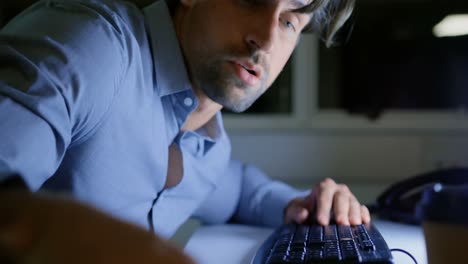 Side-view-of-tired-young-Caucasian-male-executive-sleeping-at-desk-in-a-modern-office-4k